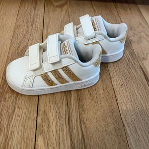 Adidas classic sneakers. With gold stripes